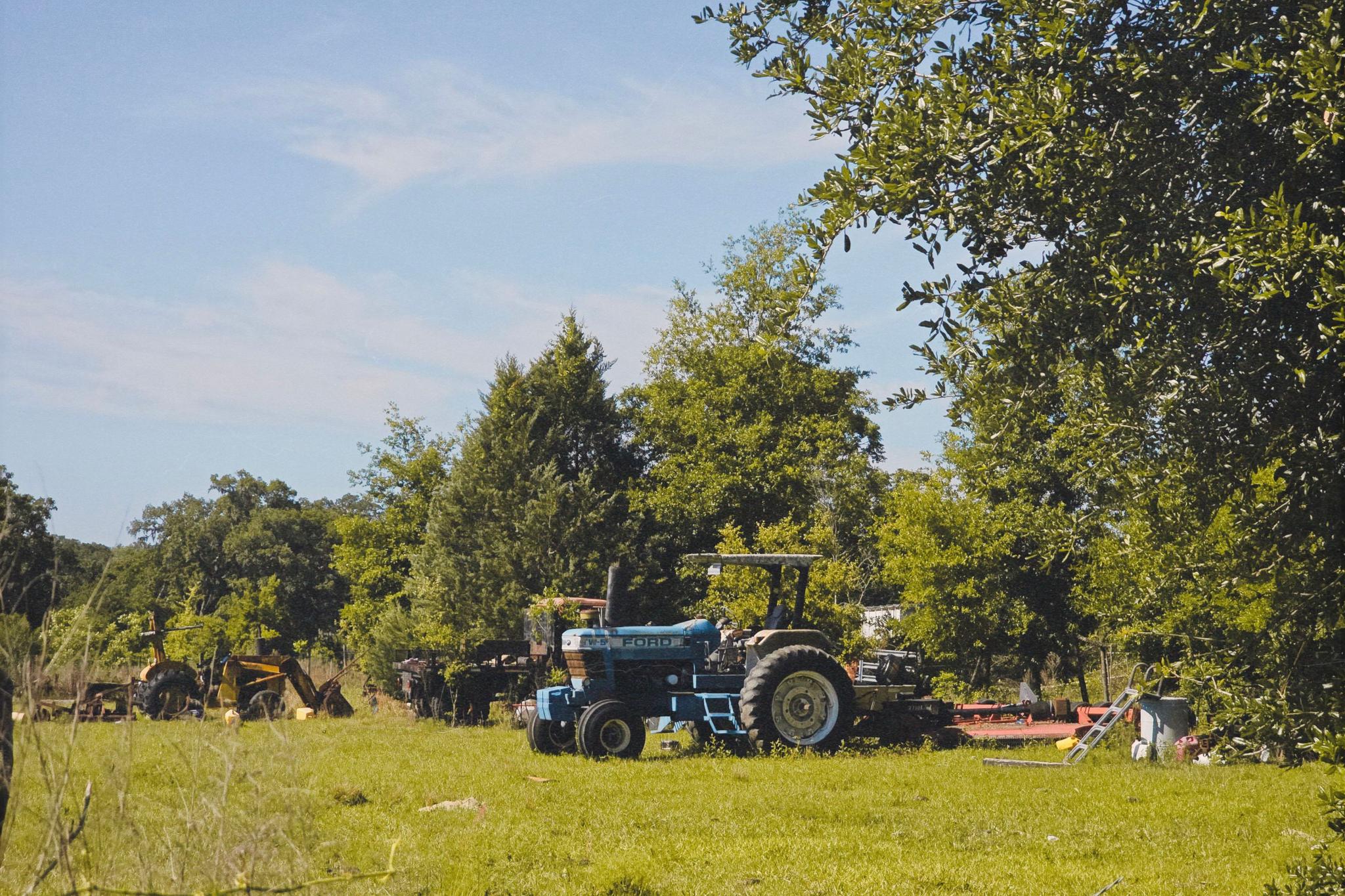 a peaceful scene in nature with a tractor suggests serenity and simplicity in rural life