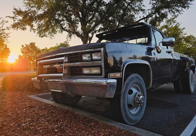 a vintage truck parked during a serene sunset evokes a sense of nostalgia and calm